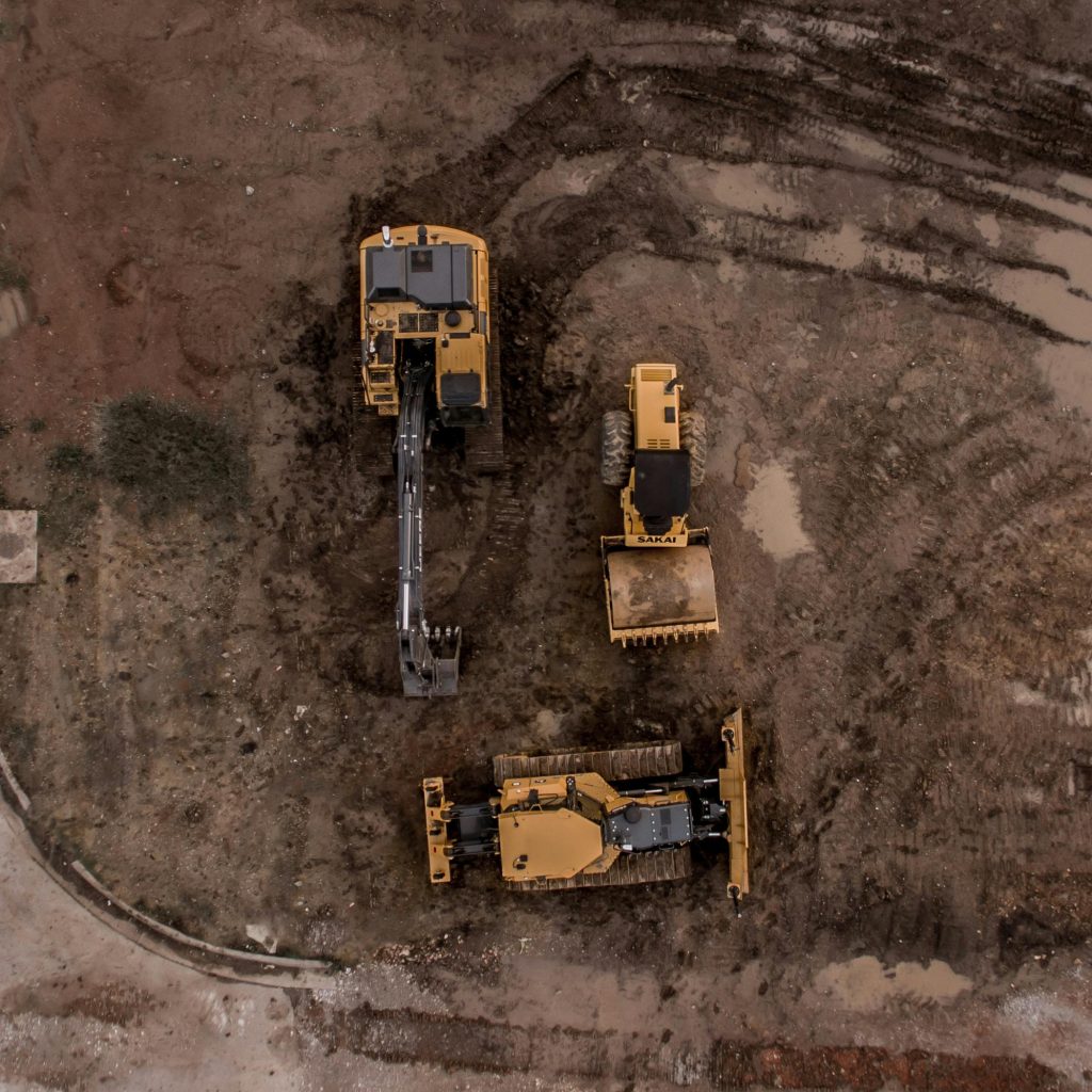 pexels photo 1579356 1579356 An aerial shot of heavy machinery at a construction site, including excavators and road rollers.