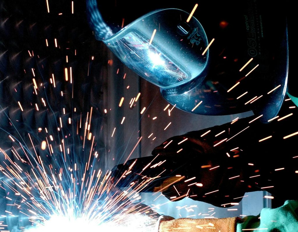 weld hot soldering radio welder 73833 73833 1 A focused welder works with metal in an industrial setting, creating vibrant sparks.
